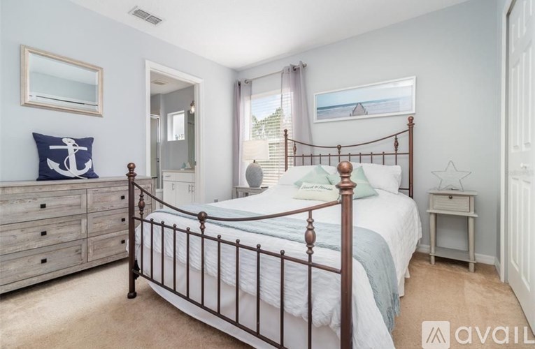 A bedroom with a bed, dresser, and nightstand.