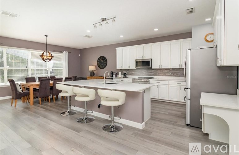 A modern kitchen with white cabinets and a large island.