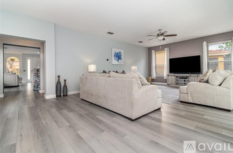 A living room with a large couch and a television.
