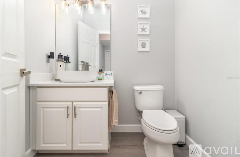 A white toilet sits next to a sink in a bathroom.