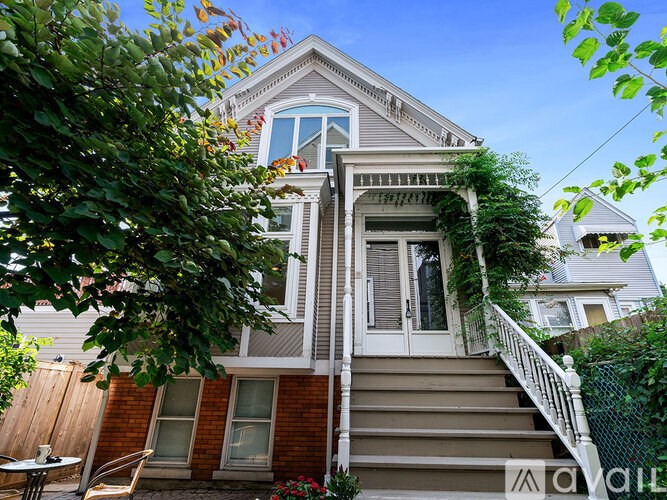 A house with a staircase leading to the front door.
