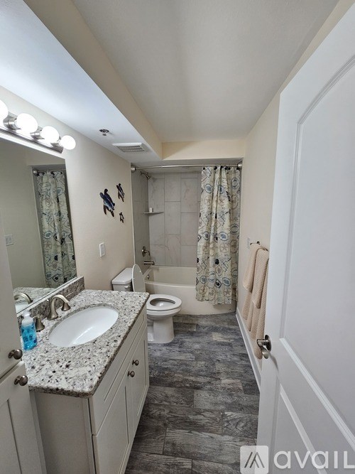 A bathroom with a sink, toilet, and shower.