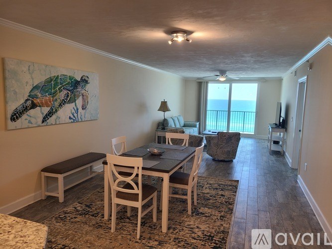 A dining room with a wooden table and chairs.