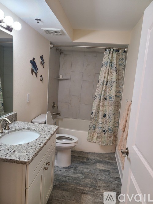 A bathroom with a sink, toilet, and shower.