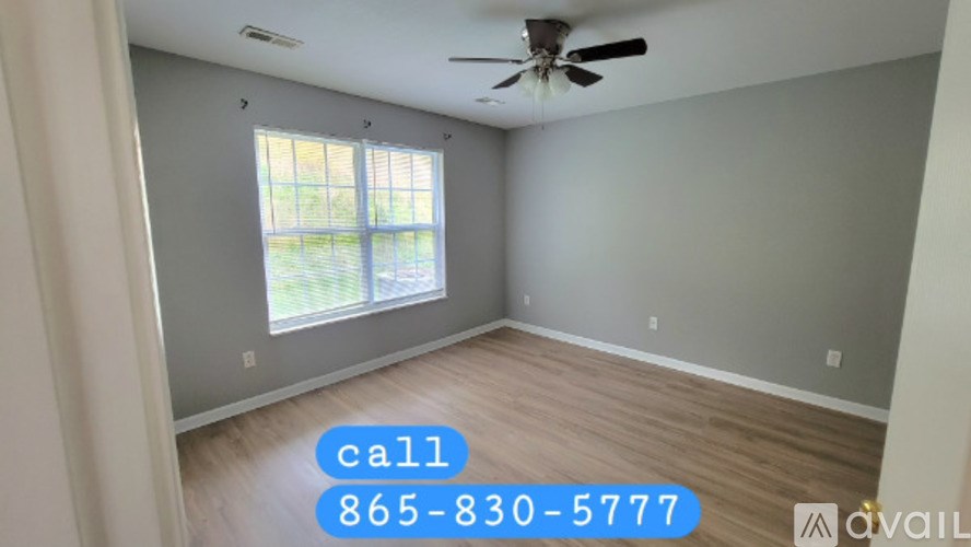 A room with a ceiling fan and a window is available for rent.