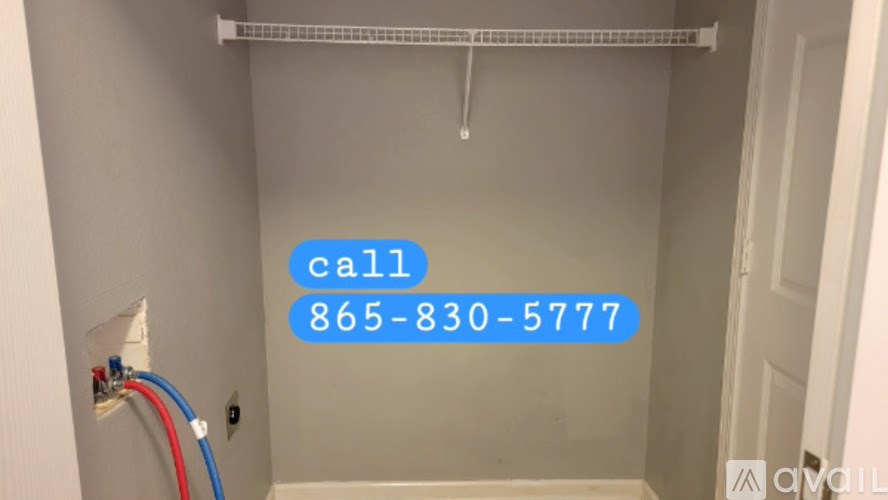 A white door with a blue call sign on the wall.