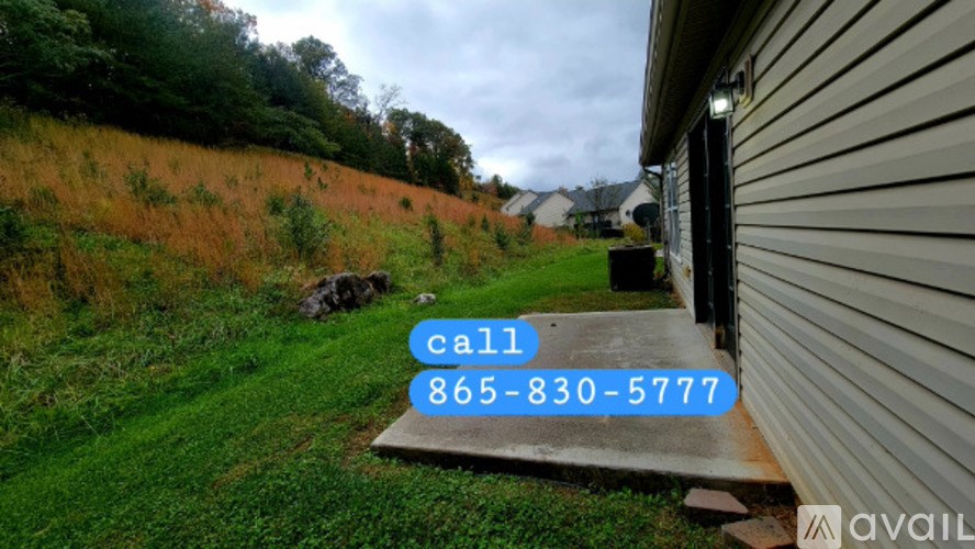 A house with a call button and a phone number on it.