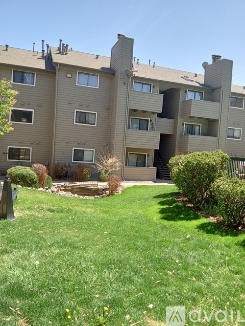 Apartment complex with a green lawn in front.
