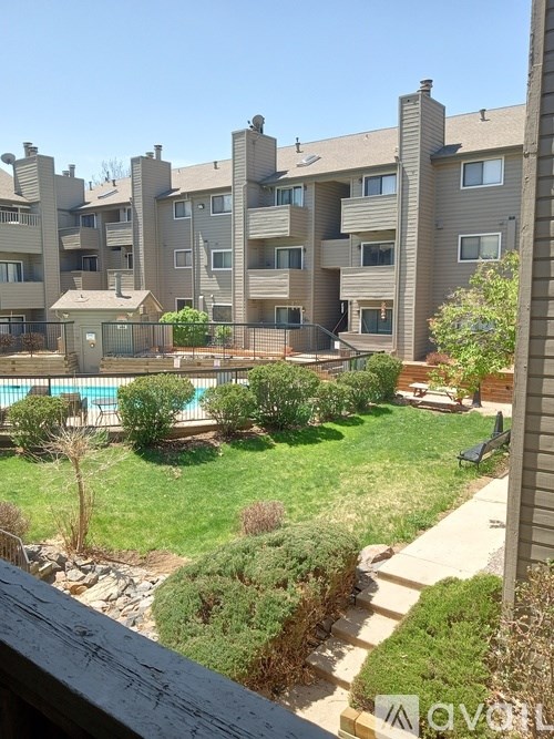 Apartment complex with a pool in the backyard.