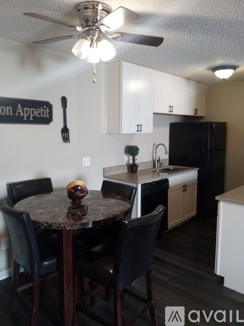 A kitchen with a table and chairs and a sign that says "on Appetit".