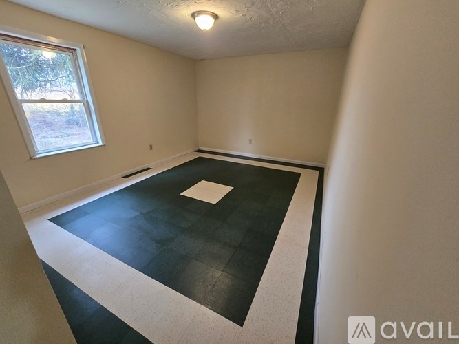 A room with a tiled floor and a window.