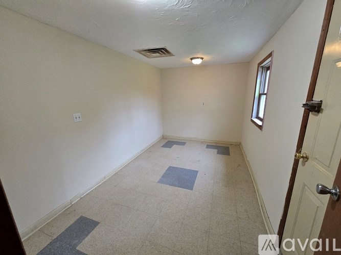 A room with a door, window, and tiled floor.