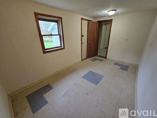 A bathroom with a toilet, sink, and mirror.