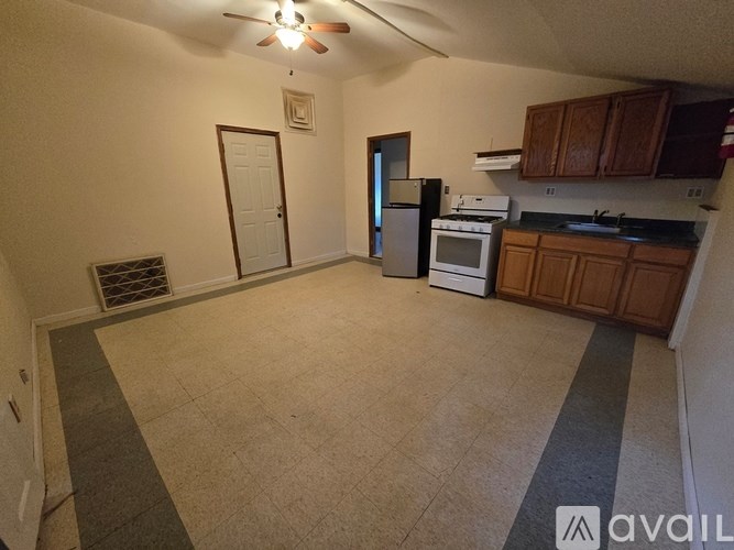 A kitchen with a refrigerator, oven, and microwave.
