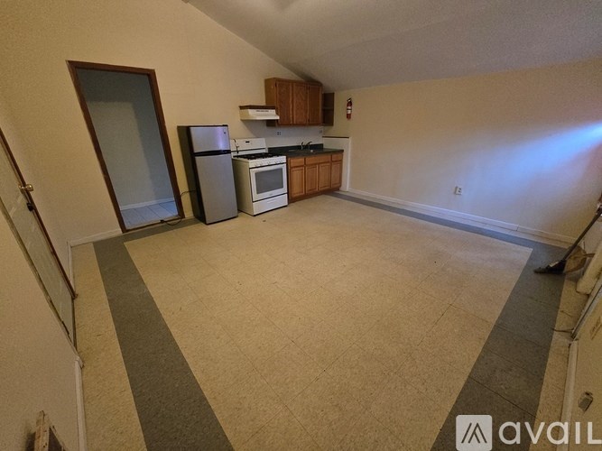 A kitchen area with a refrigerator, oven, and microwave.