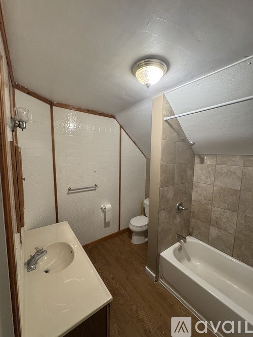 A bathroom with a white sink and a white bathtub.