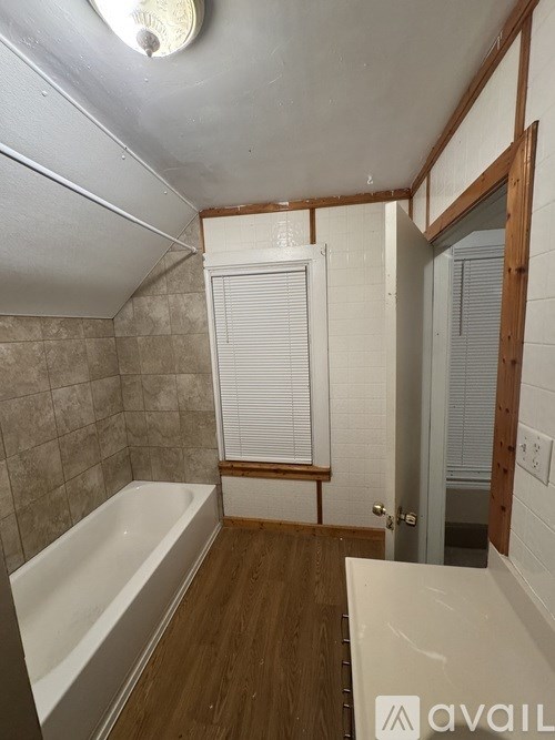 A bathroom with a tub and a toilet.
