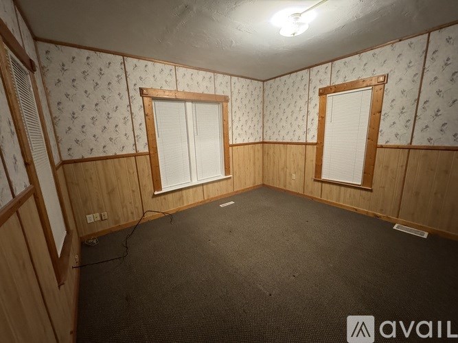 A room with wooden walls and a carpeted floor.