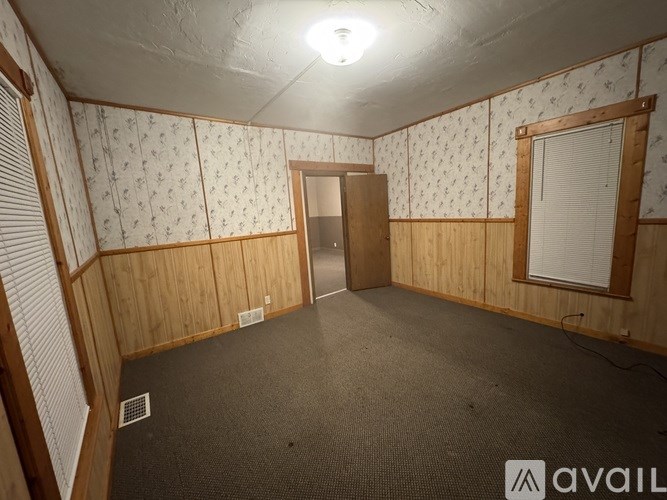 A room with wooden walls and a carpeted floor.