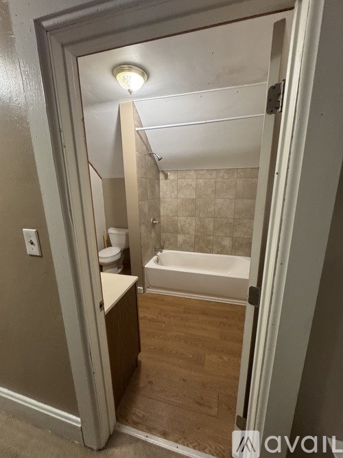 A bathroom with a toilet, sink, and bathtub.