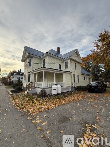 A house with a car parked in front of it.