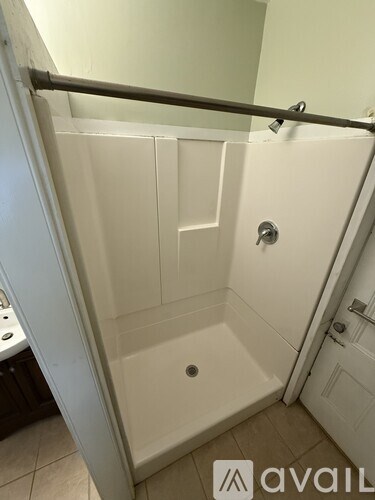A white bathroom with a walk in shower.