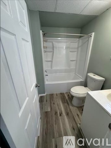 A small bathroom with a toilet, sink, and bathtub.
