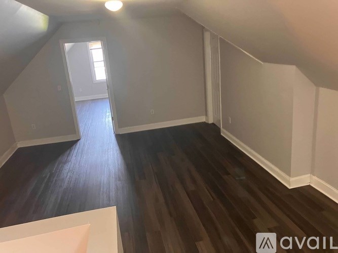 A room with wooden floors and white walls.