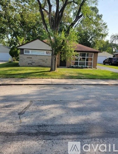 A house with a tree in front of it.