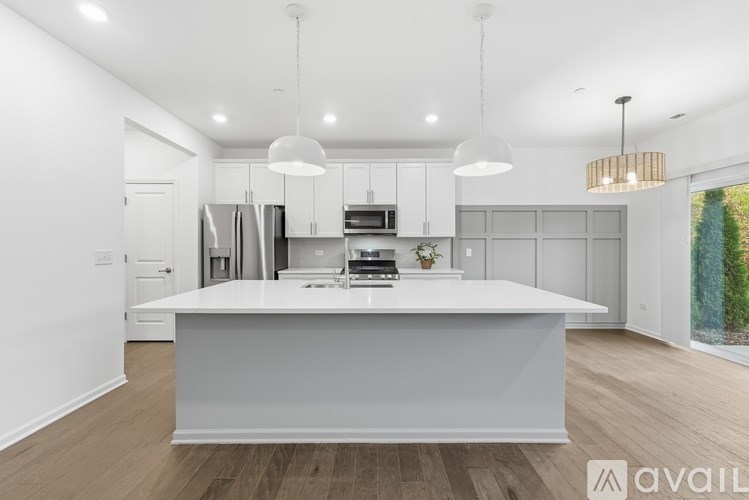 A modern kitchen with a large island in the center.