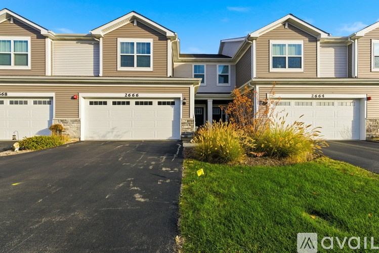 A row of houses with garages and driveways.