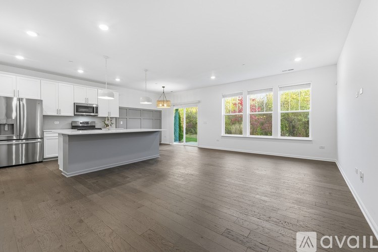 A spacious kitchen with a refrigerator, stove, and oven.