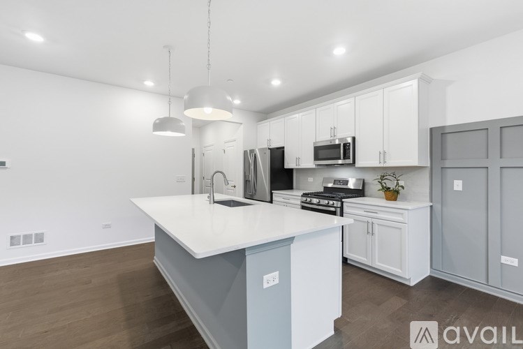A modern kitchen with a large island in the center.