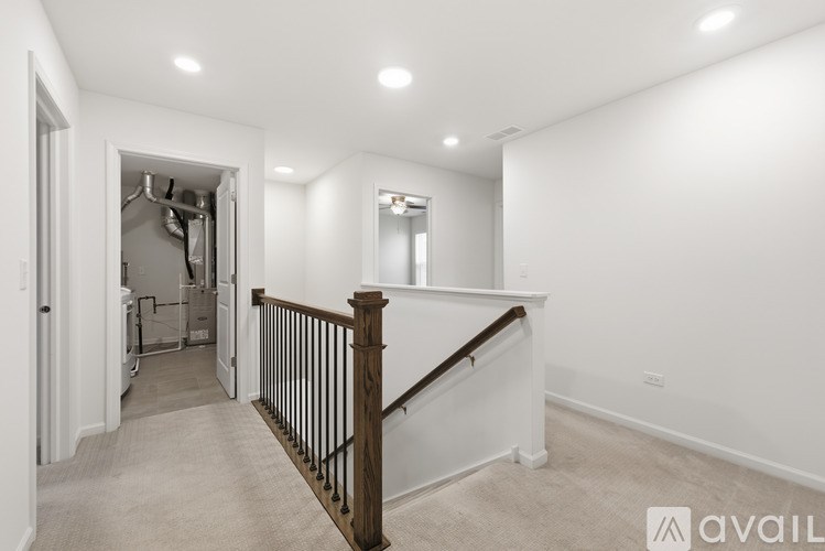 A spacious room with a staircase leading to the upper level.