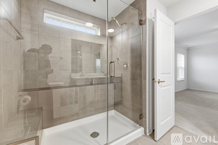 A bathroom with a walk-in shower and a toilet.