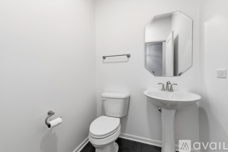 A white toilet and sink in a bathroom.