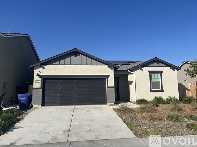 A modern house with a large garage door.