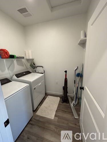 A small laundry room with a washer and dryer.