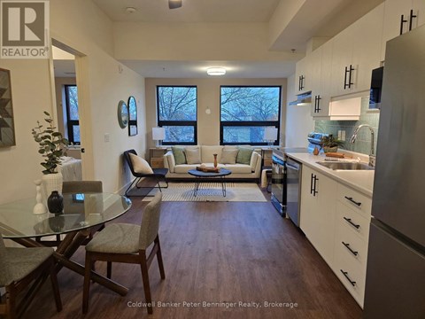 A modern kitchen with a dining table and chairs.