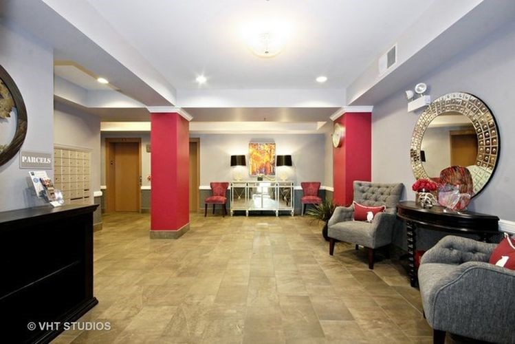 A spacious waiting area with a reception desk and comfortable seating.