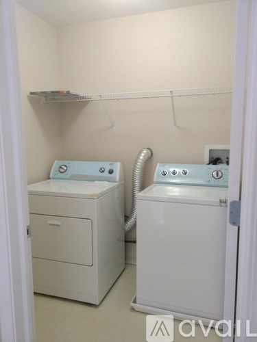 A small laundry room with a washer and dryer.