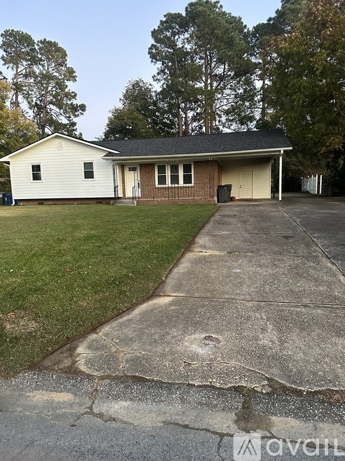 A house with a white garage door and a driveway in front.