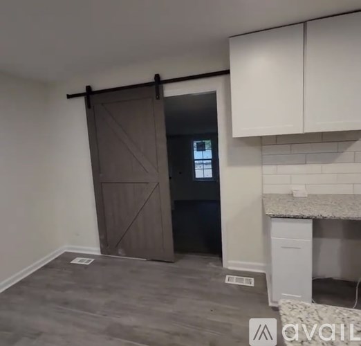 A room with a brown door and a white counter.