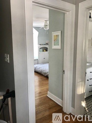 A hallway with a bedroom at the end.