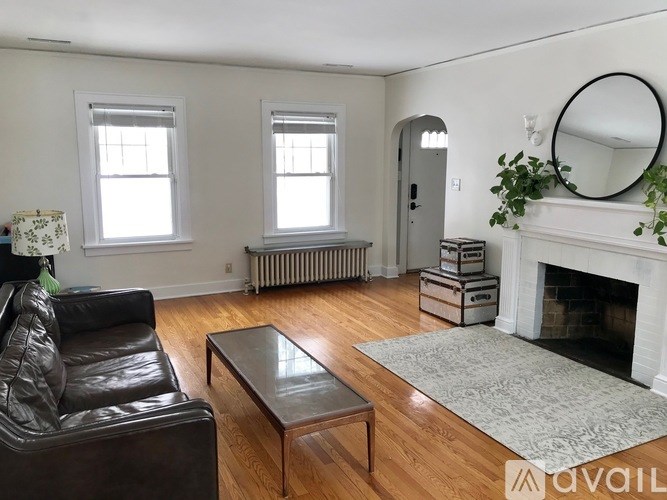 A living room with a fireplace and a couch.
