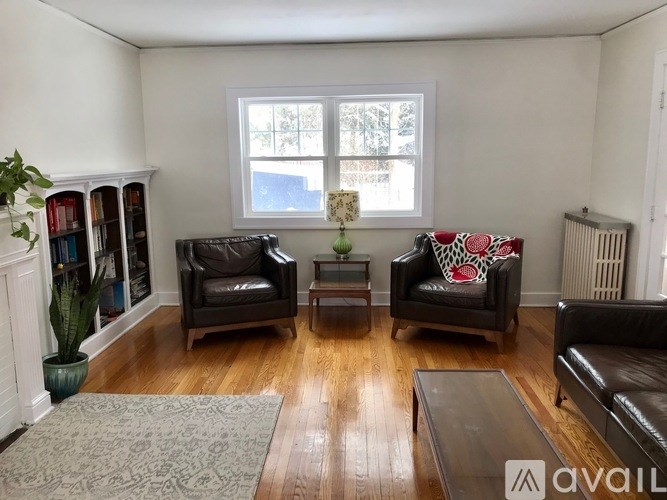 A living room with two chairs and a couch.