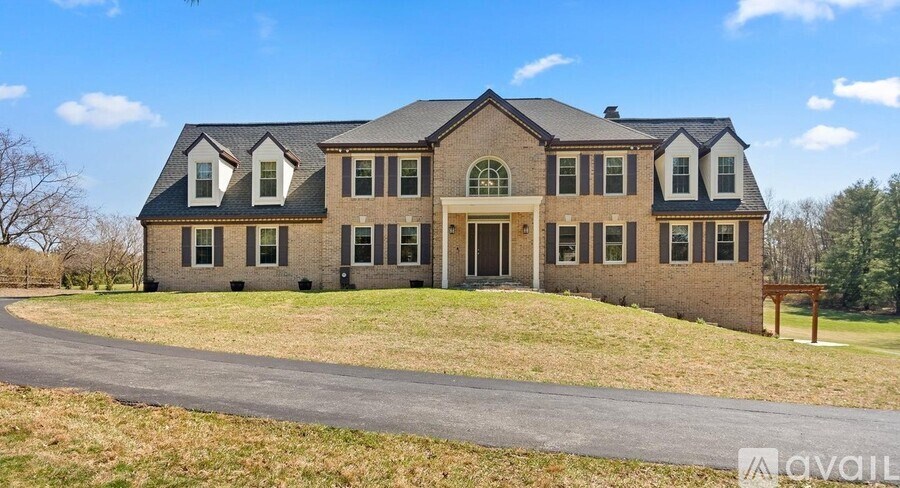 A large house with a driveway in front of it.