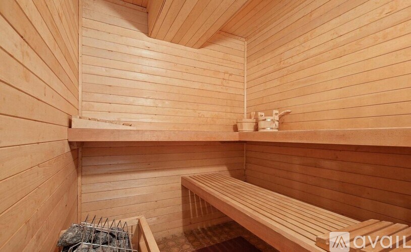 A wooden sauna with benches and a shelf.