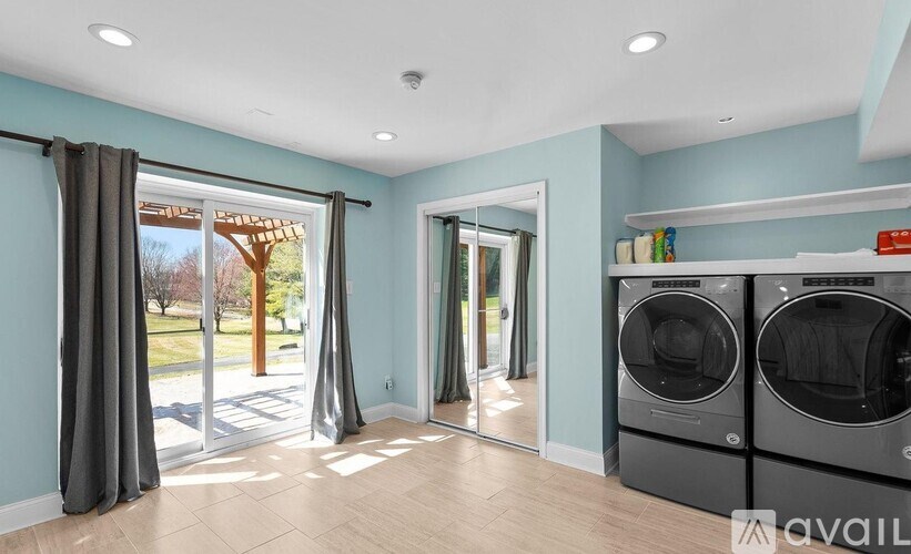 A kitchen with a washing machine and dryer in it.