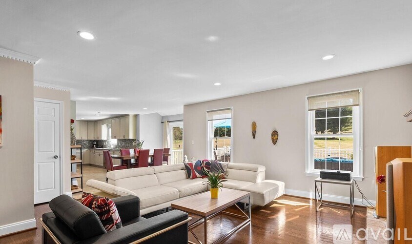 A living room with a white couch and a coffee table.